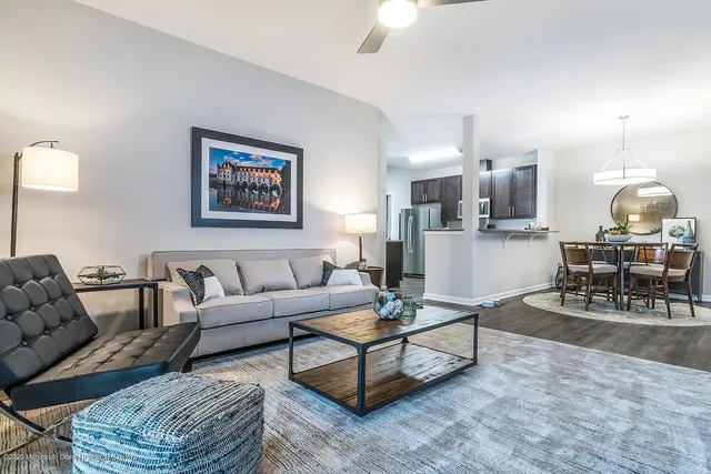 a living room with furniture and a dining table