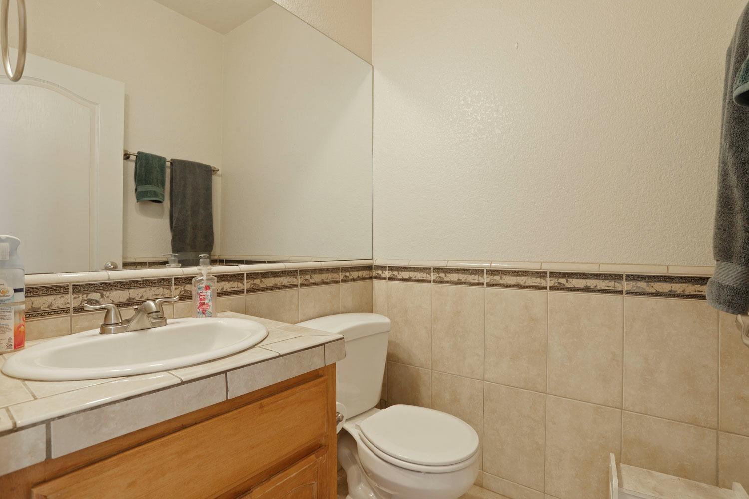 16160 Moore Road Lodi, CA 95242 - Photo 19 of 38 a bathroom with a sink a toilet and shower