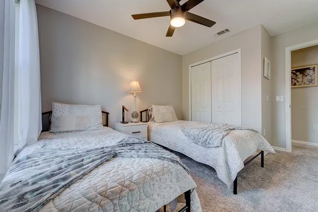 a bedroom with a bed a window and dresser