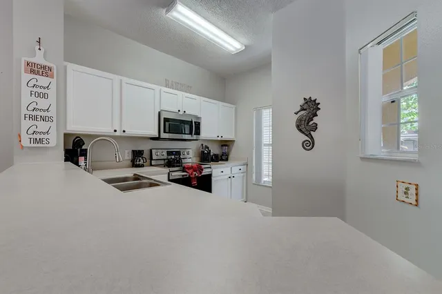 a kitchen with a sink cabinets and a refrigerator