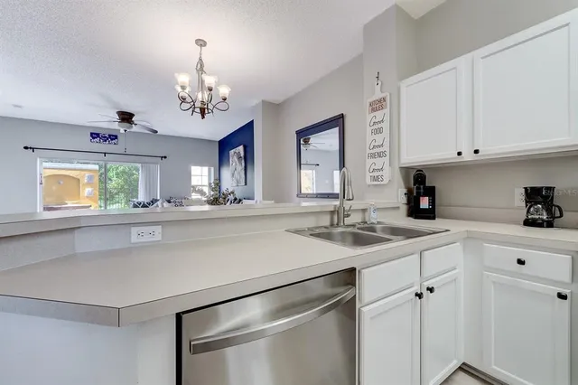 a kitchen with stainless steel appliances white cabinets and a stove top oven