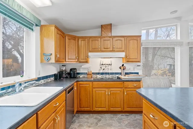 a kitchen with a sink stove and cabinets