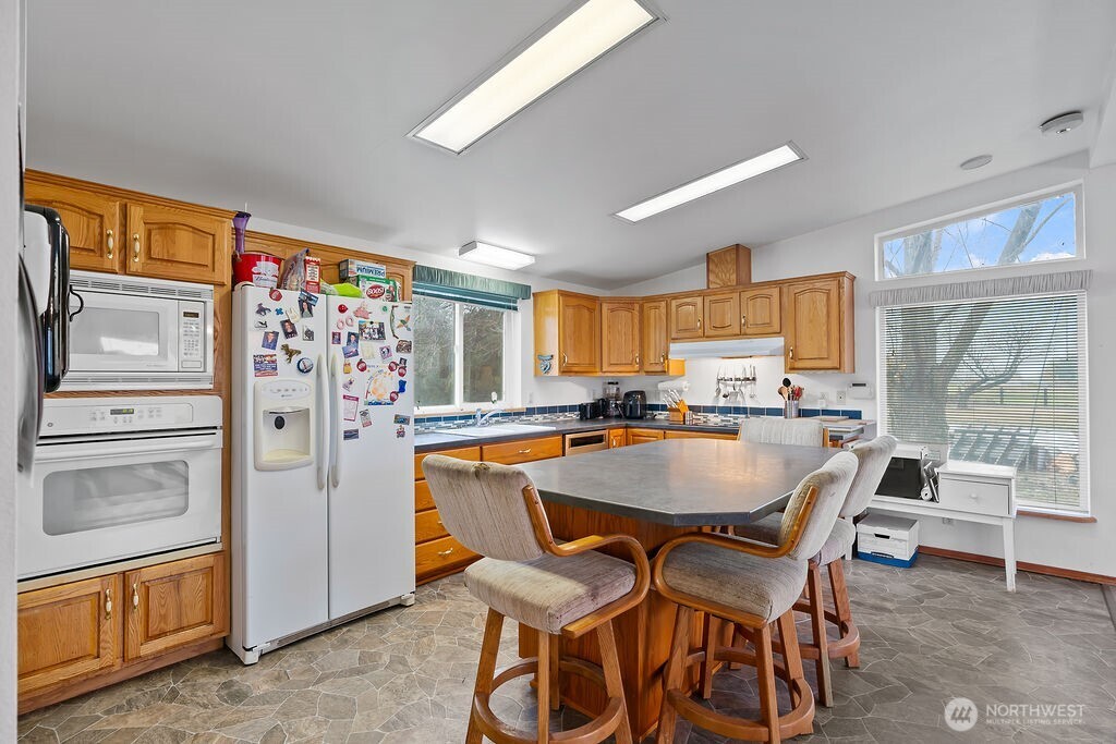 163106 West North River Road Prosser, WA 99350 - Photo 12 of 31 a dining room with stainless steel appliances granite countertop a dining table and chairs