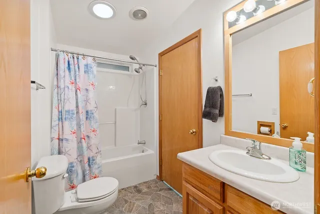 a bathroom with a sink toilet tub and shower