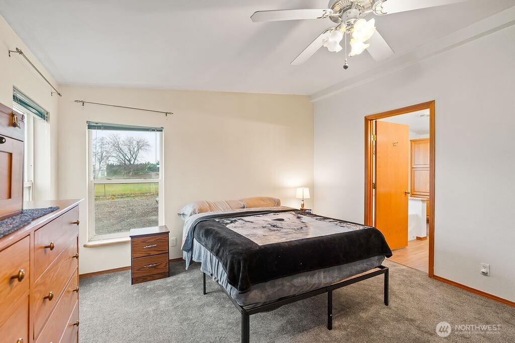 163106 West North River Road Prosser, WA 99350 - Photo 16 of 31 a bedroom with a bed and a chandelier
