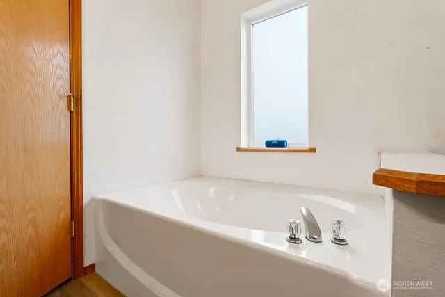 a bathroom with a tub and a sink