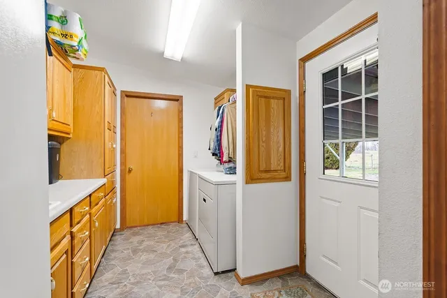 a view of a kitchen with wooden floor and windows
