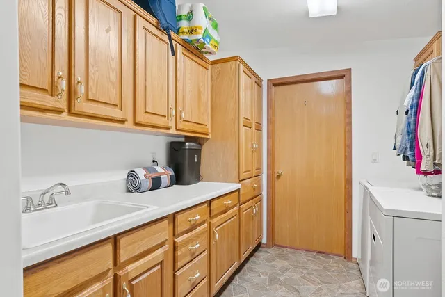 a kitchen with stainless steel appliances granite countertop a sink a refrigerator and a cabinets