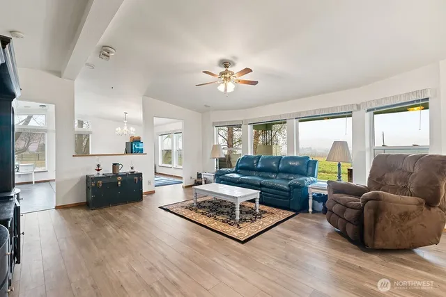a living room with furniture fireplace and a large window
