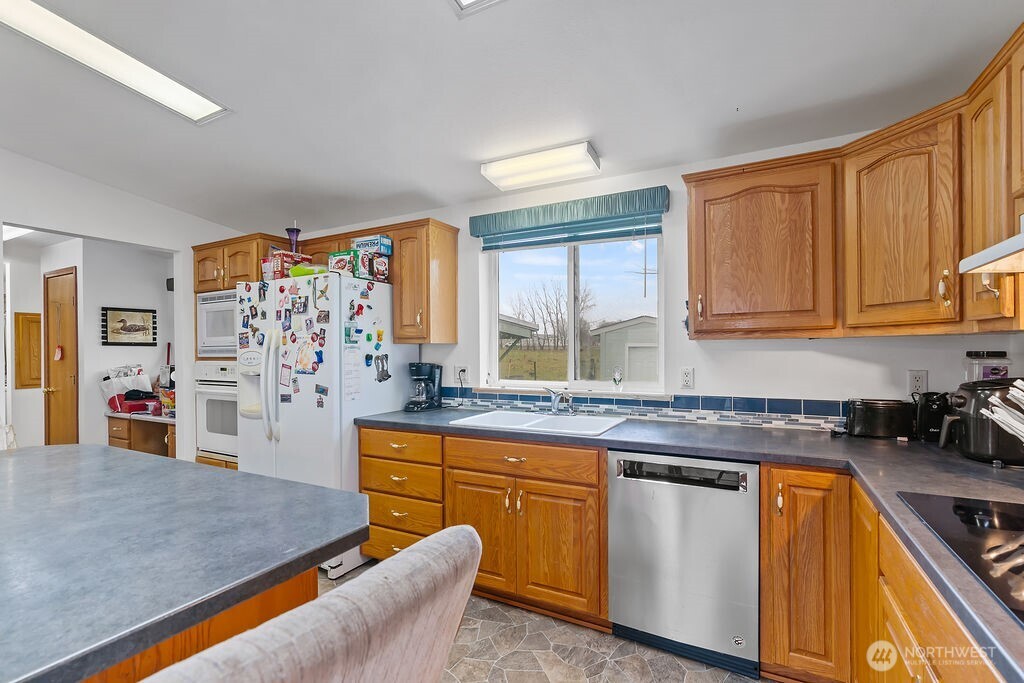 163106 West North River Road Prosser, WA 99350 - Photo 10 of 31 a kitchen with stainless steel appliances granite countertop a stove a sink and a microwave