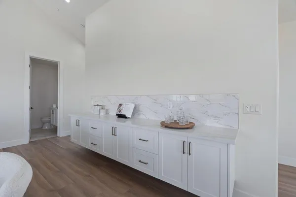 a kitchen with a sink cabinets and wooden floor