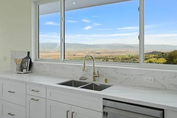 a kitchen with sink and cabinets