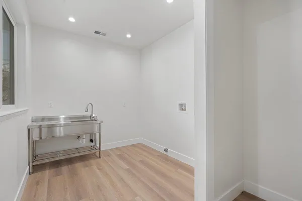 a view of a hallway with wooden floor and closet