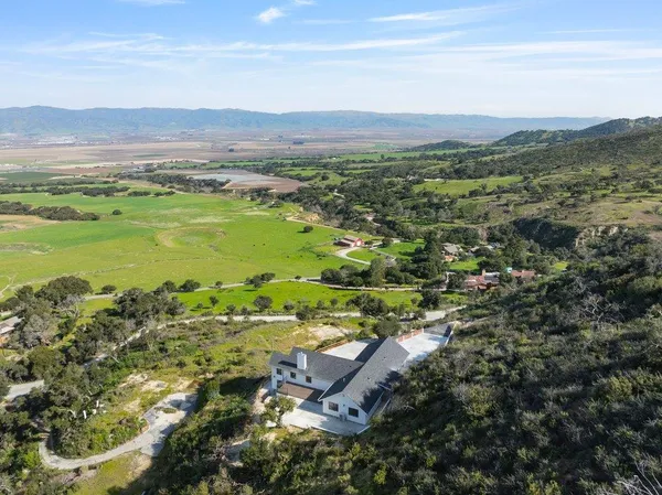 an aerial view of a house with a yard