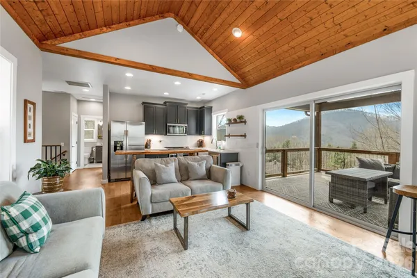 a view of a living room kitchen and a wooden floor