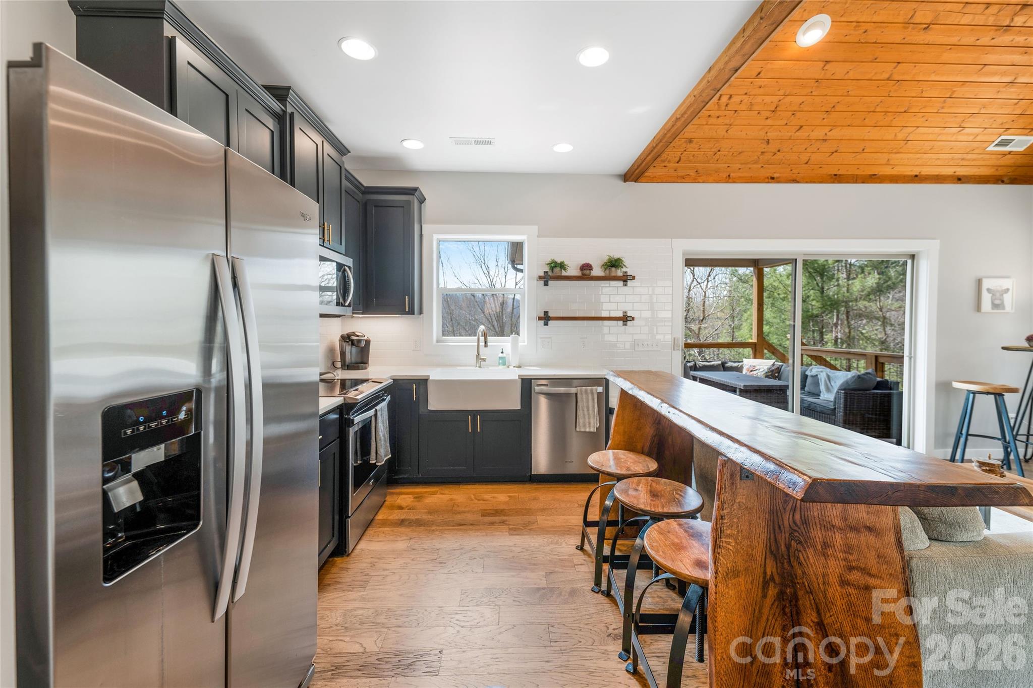 54 Weldon Way Fairview, NC 28730 - Photo 19 of 47 a kitchen with stainless steel appliances kitchen island granite countertop a refrigerator and a stove