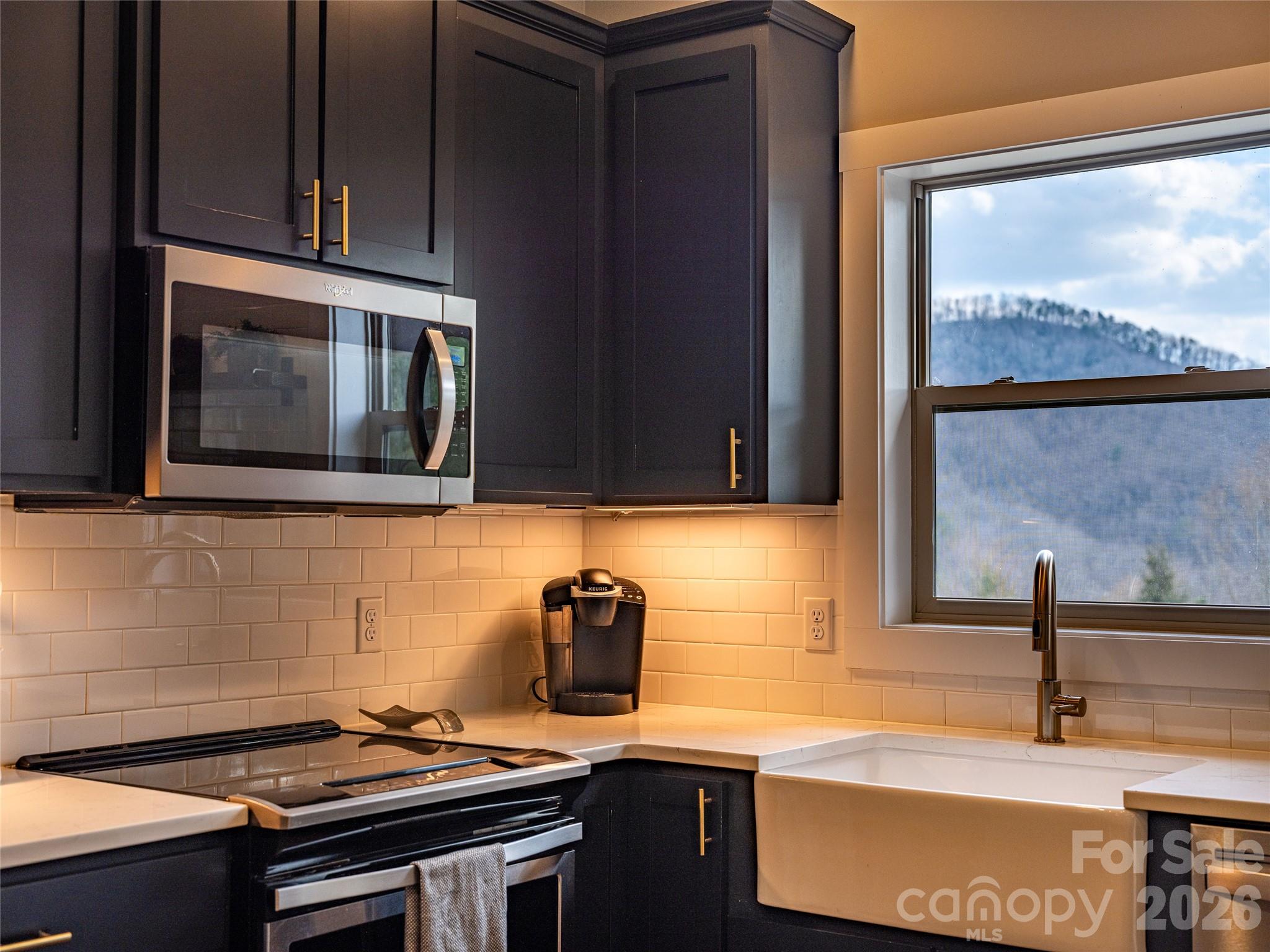 54 Weldon Way Fairview, NC 28730 - Photo 20 of 47 a kitchen with a sink and a stove top oven