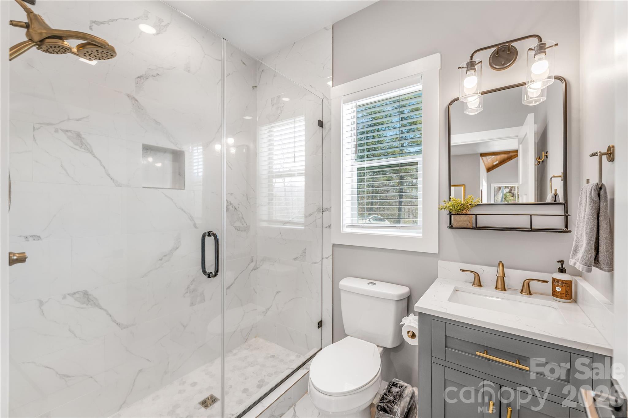 54 Weldon Way Fairview, NC 28730 - Photo 21 of 47 a bathroom with a sink a toilet and shower