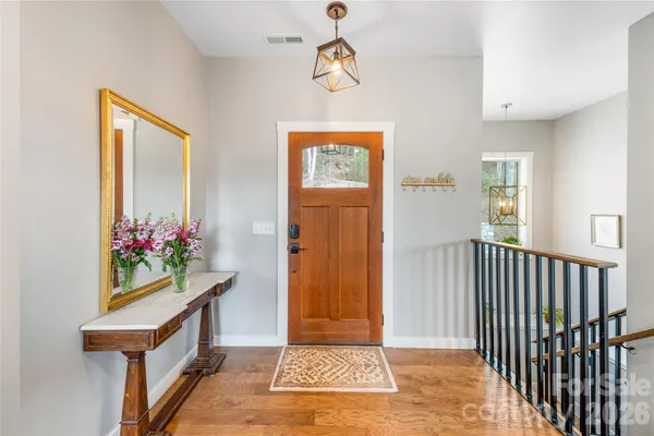 a view of an entryway and wooden floor