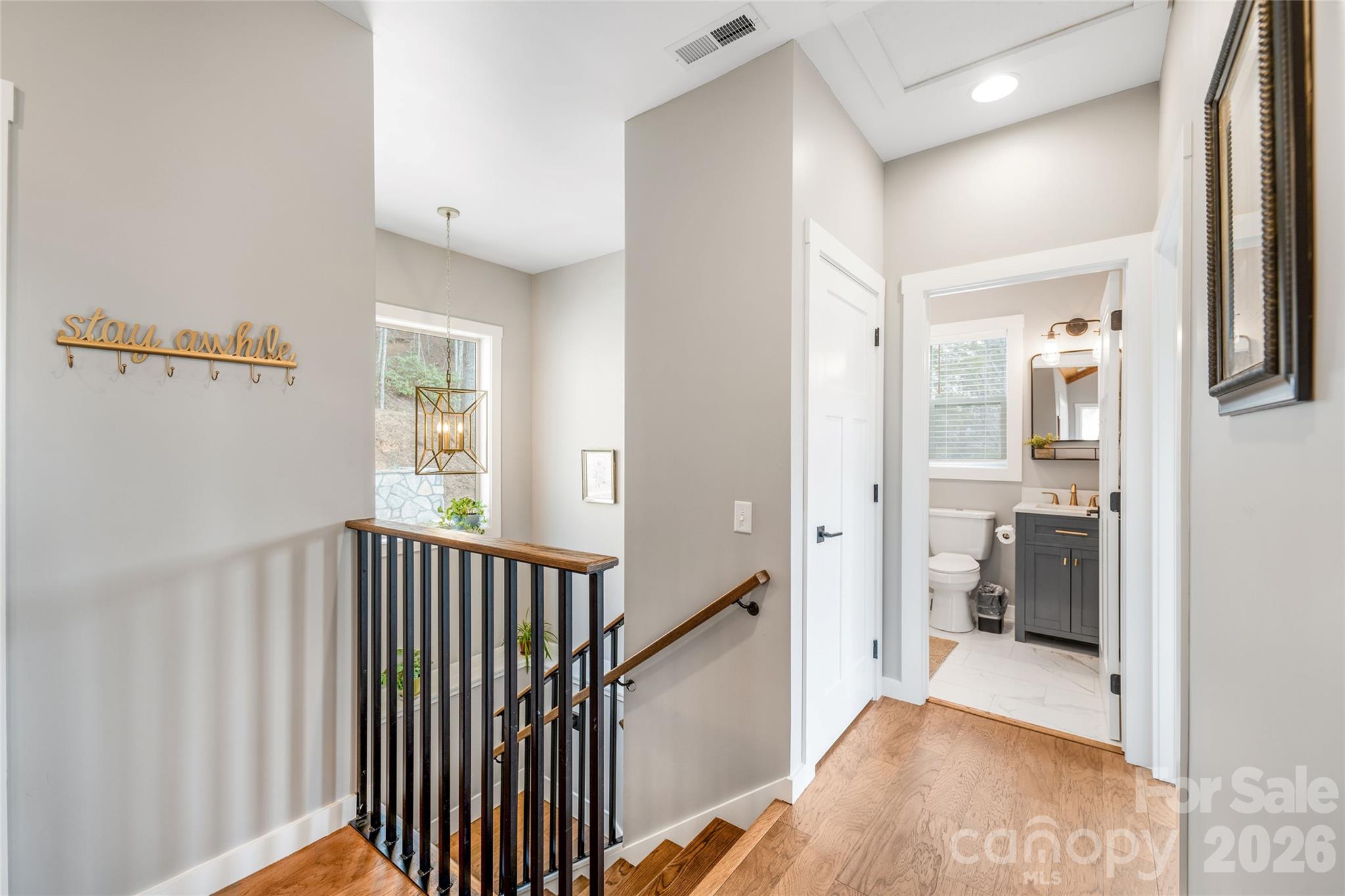 54 Weldon Way Fairview, NC 28730 - Photo 28 of 47 a view of a hallway with a livingroom and a bathroom with bathtub