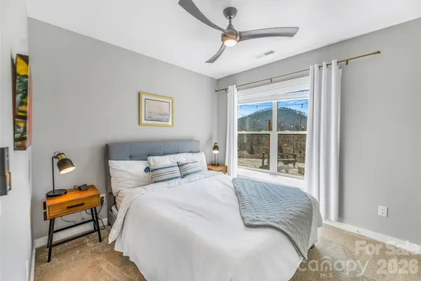 a bedroom with a bed and glass door