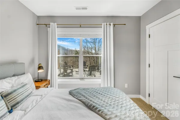 a bedroom with a large bed and a large window