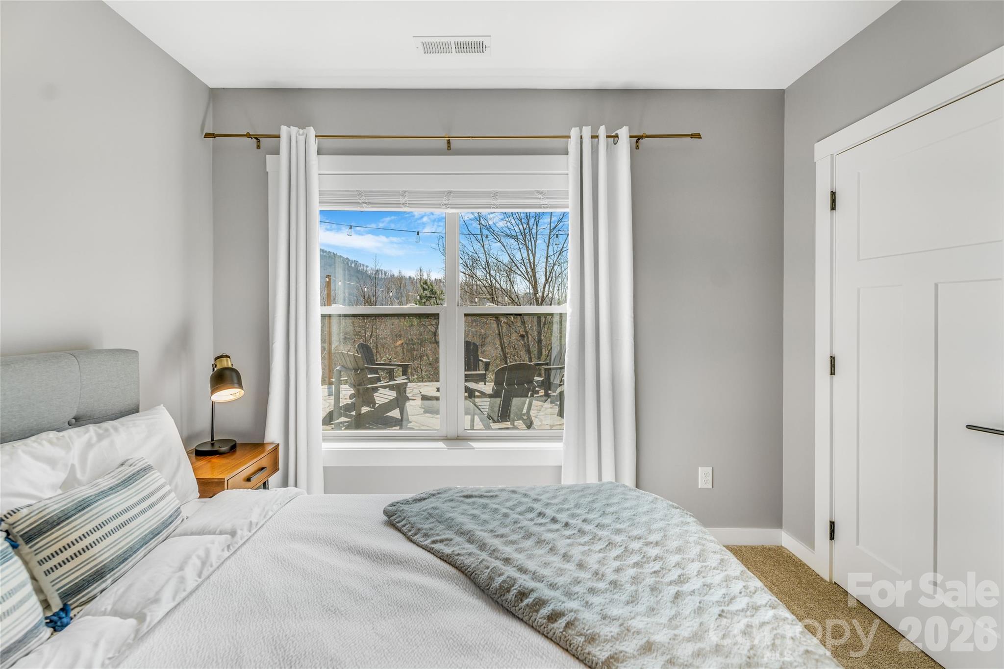 54 Weldon Way Fairview, NC 28730 - Photo 30 of 47 a bedroom with a bed and glass door