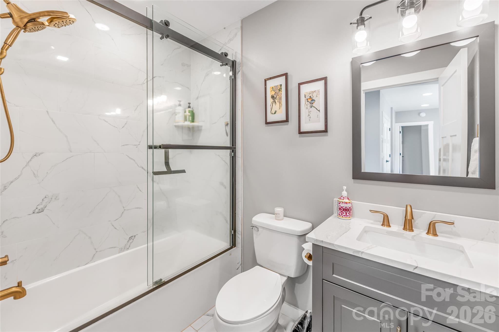 54 Weldon Way Fairview, NC 28730 - Photo 32 of 47 a bathroom with a granite countertop toilet sink and shower