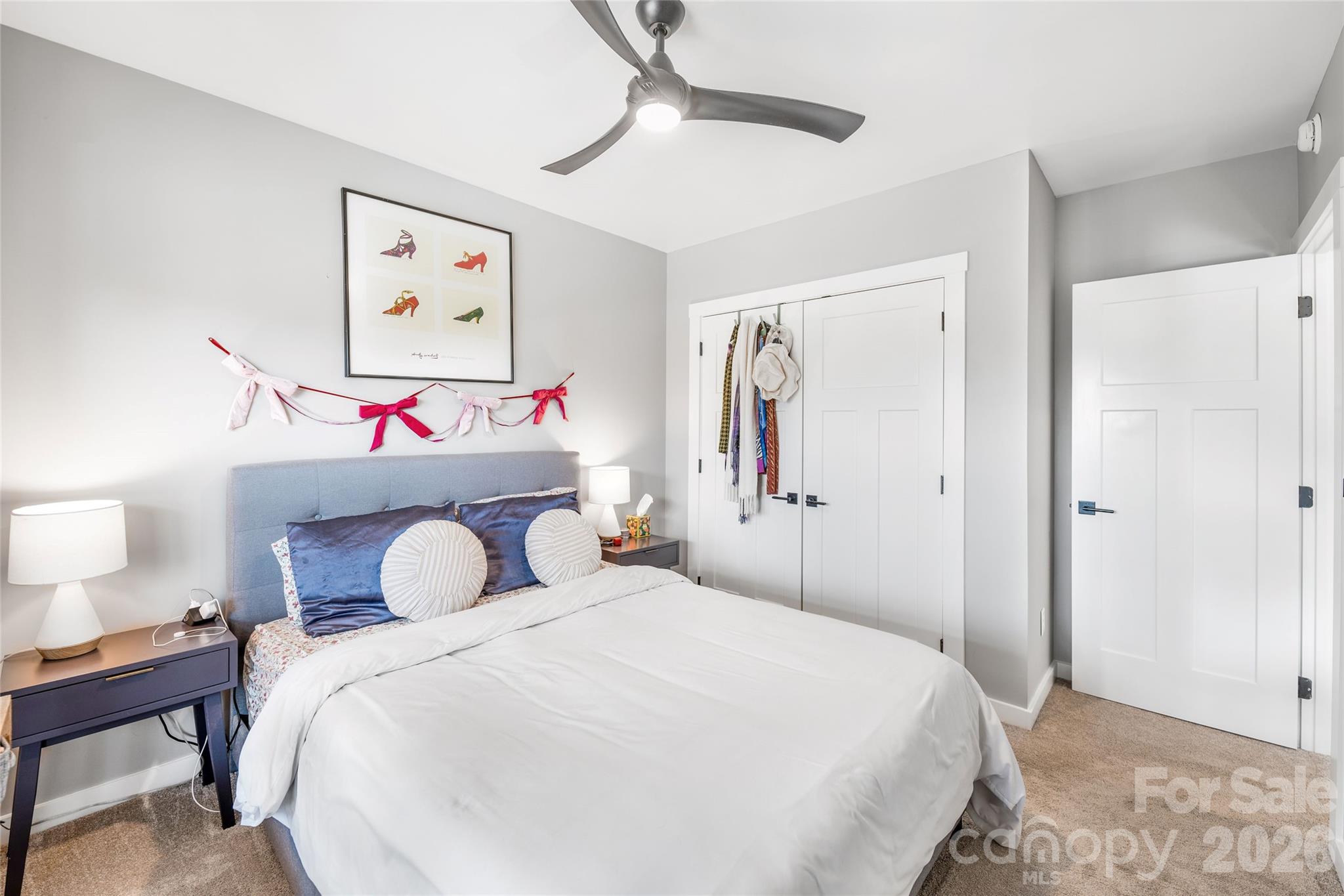 54 Weldon Way Fairview, NC 28730 - Photo 35 of 47 a bedroom with a bed and a chandelier