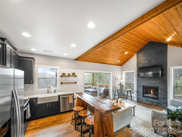 a dining room with fireplace furniture and a large window