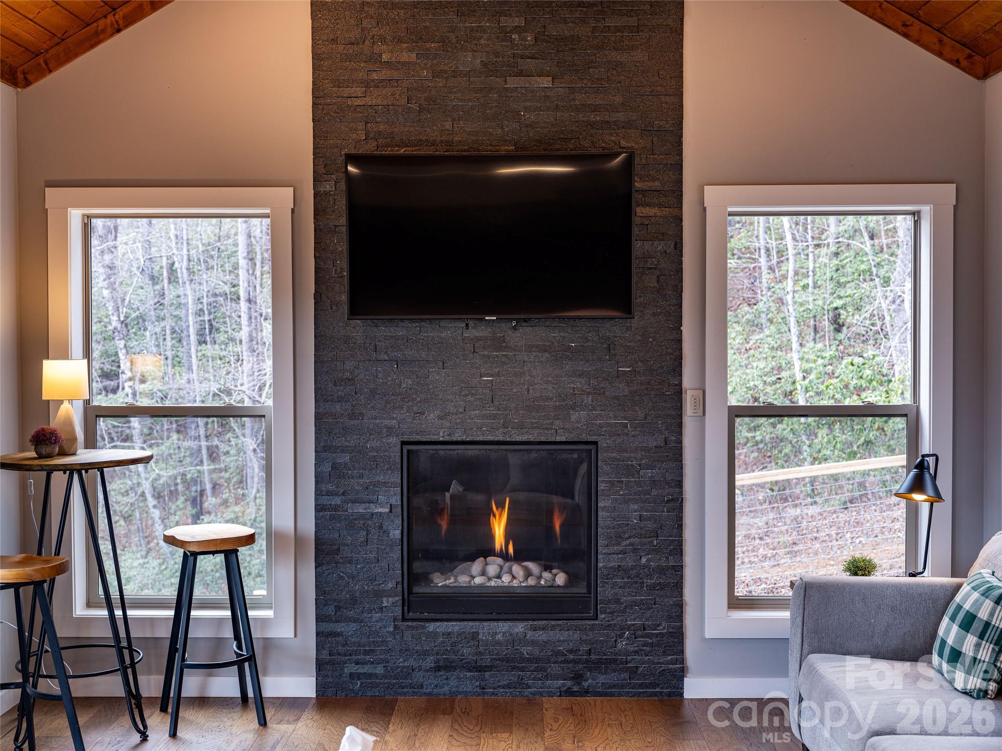 54 Weldon Way Fairview, NC 28730 - Photo 10 of 47 a living room with furniture a flat screen tv and a fireplace
