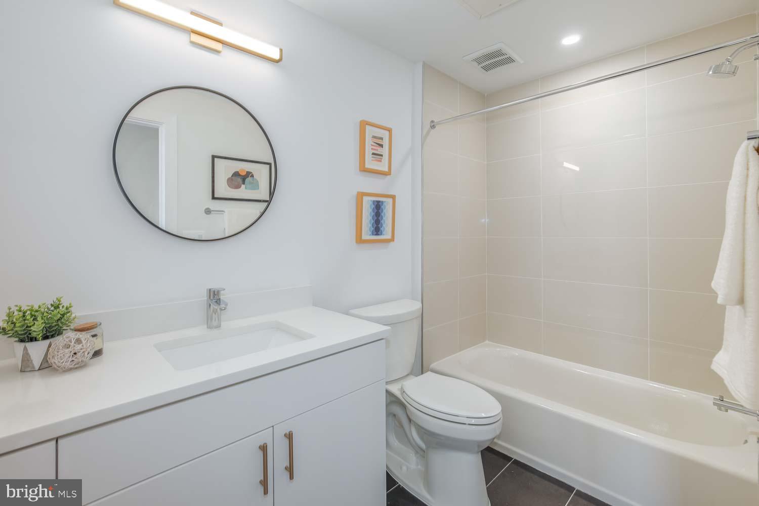 2310 4th Street Northeast, Unit 22 Washington, DC 20002 - Photo 11 of 18 a bathroom with a sink a toilet and a bathtub
