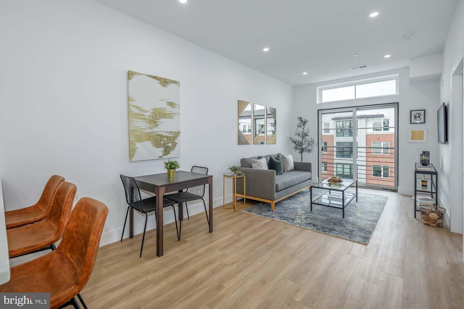 2310 4th Street Northeast, Unit 22 Washington, DC 20002 - Photo 5 of 18 a living room with furniture and a wooden floor