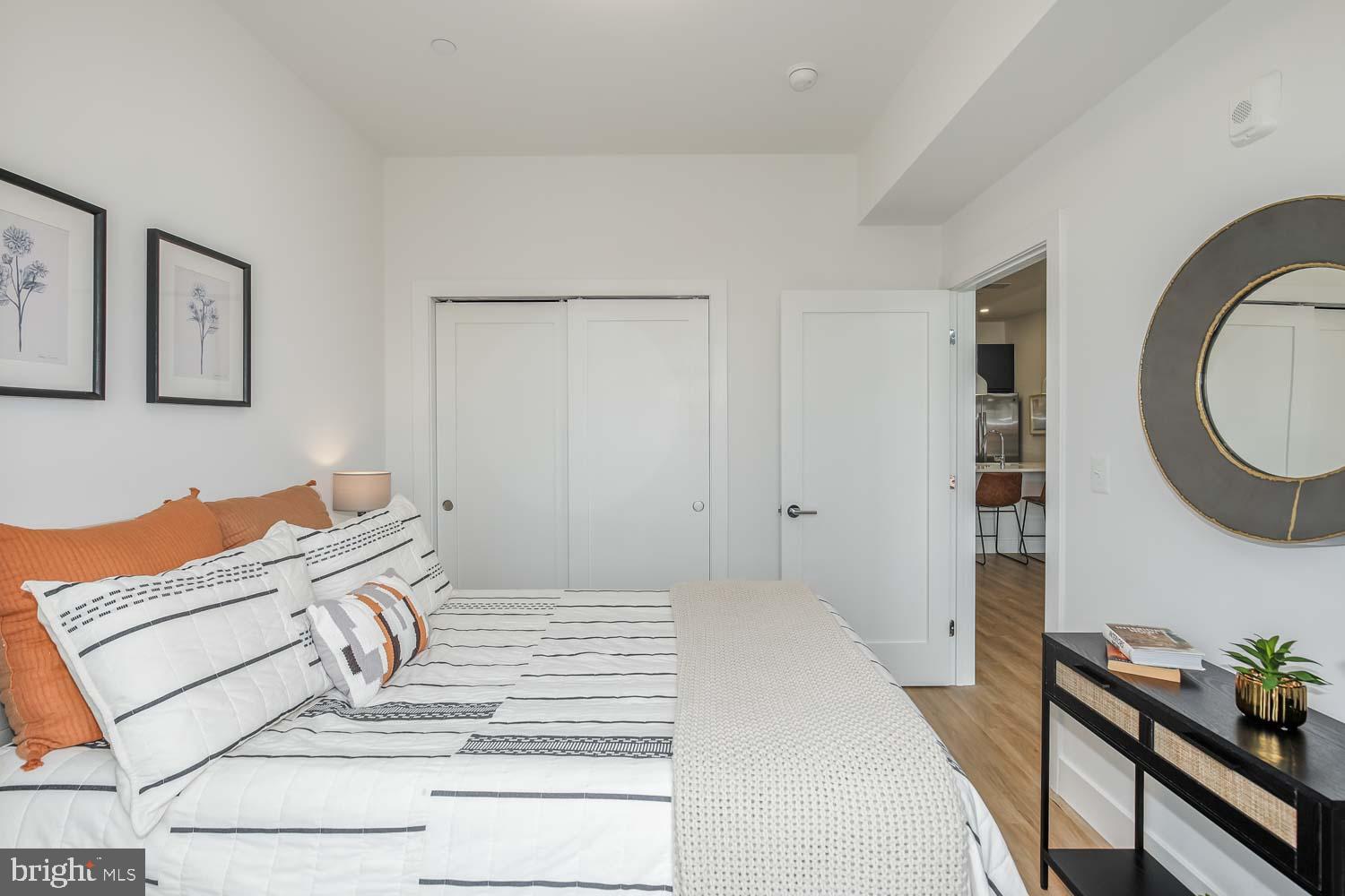 2310 4th Street Northeast, Unit 22 Washington, DC 20002 - Photo 8 of 18 a bedroom with a bed and a mirror