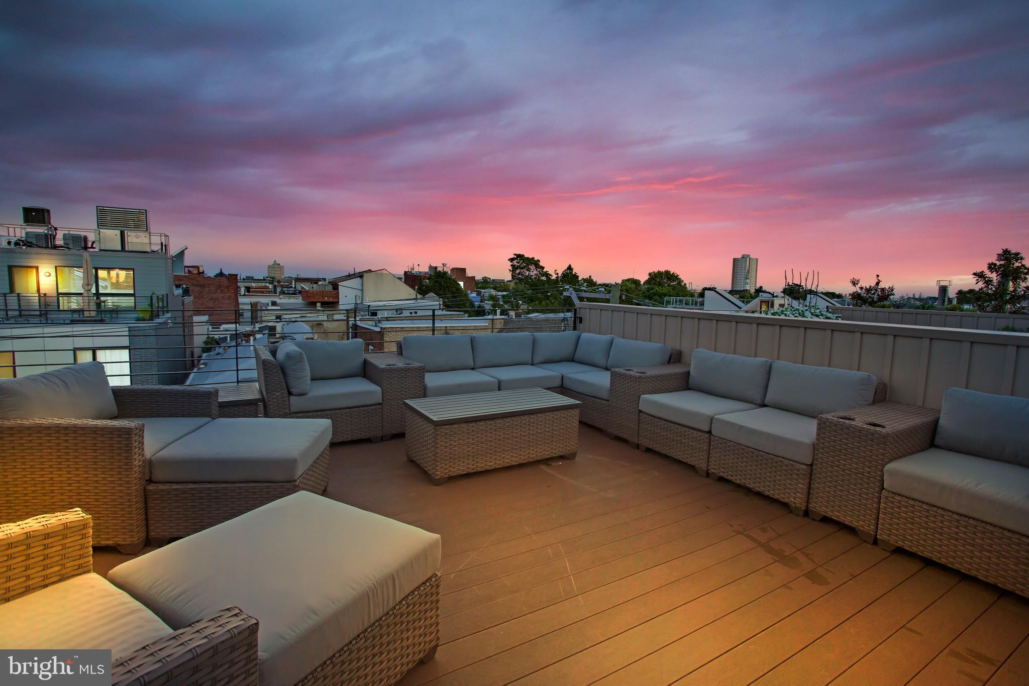 a view of a terrace with couches and sky view