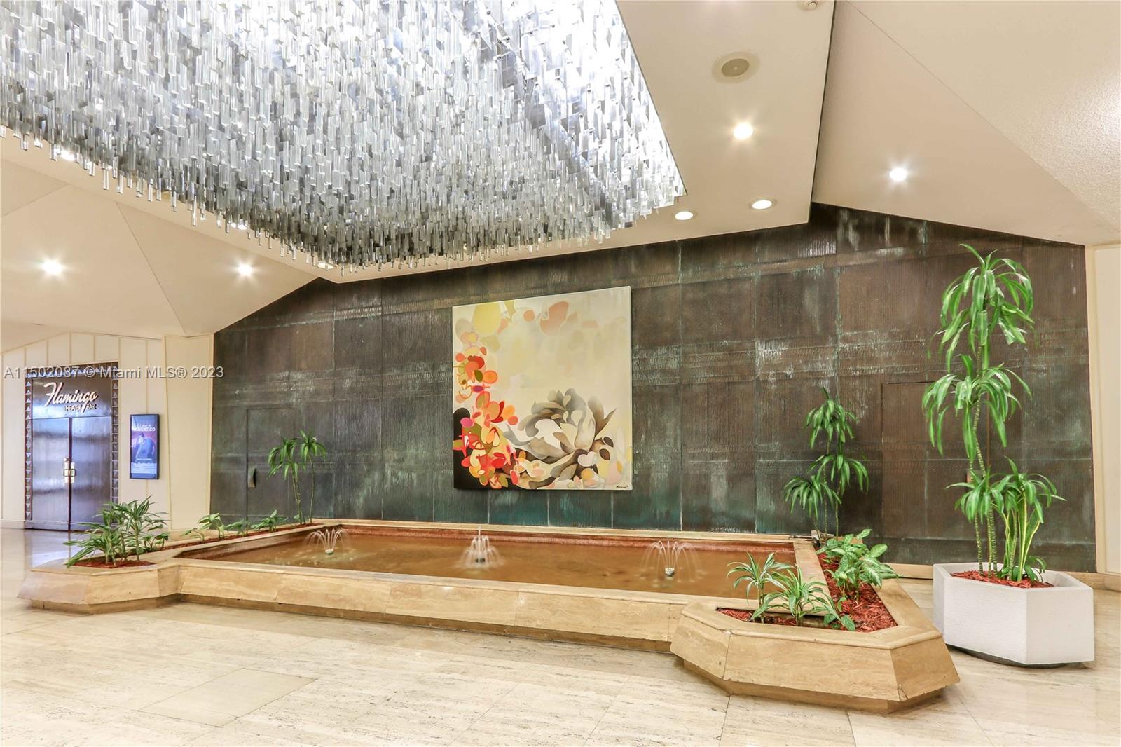 999 Brickell Bay Drive, Unit 1908 Miami, FL 33131 - Photo 15 of 57 a living room with a couch and a potted plant