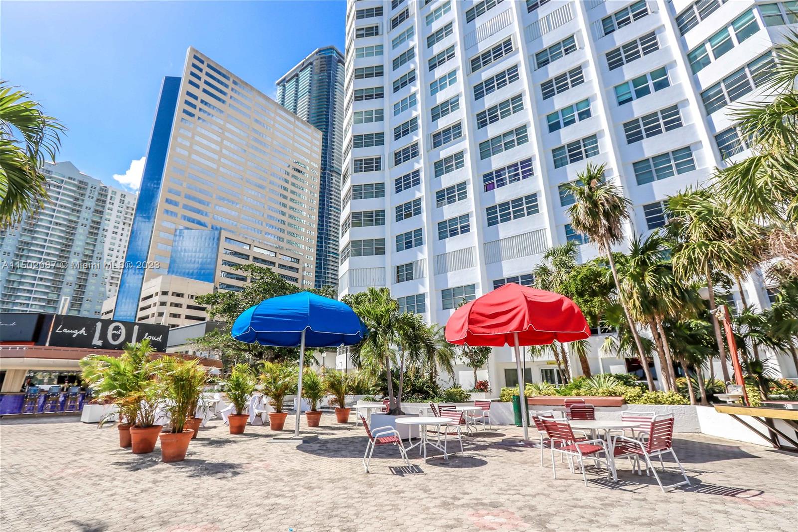 999 Brickell Bay Drive, Unit 1908 Miami, FL 33131 - Photo 25 of 57 a view of a patio with a table and chairs under an umbrella