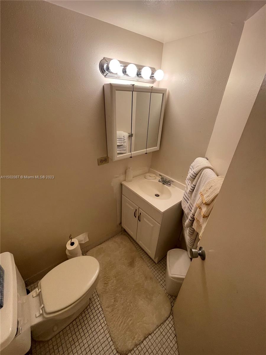 999 Brickell Bay Drive, Unit 1908 Miami, FL 33131 - Photo 34 of 57 a bathroom with a toilet sink and mirror