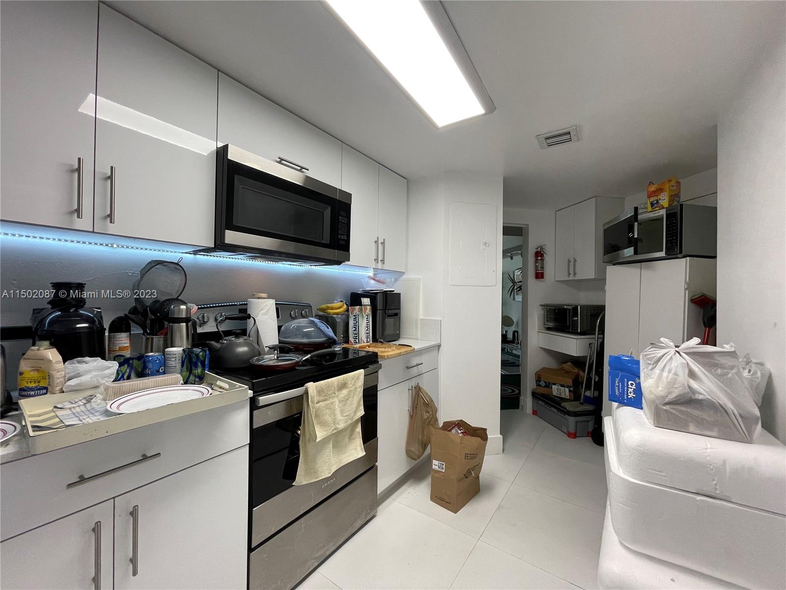 999 Brickell Bay Drive, Unit 1908 Miami, FL 33131 - Photo 35 of 57 a kitchen with stainless steel appliances granite countertop a stove and a sink