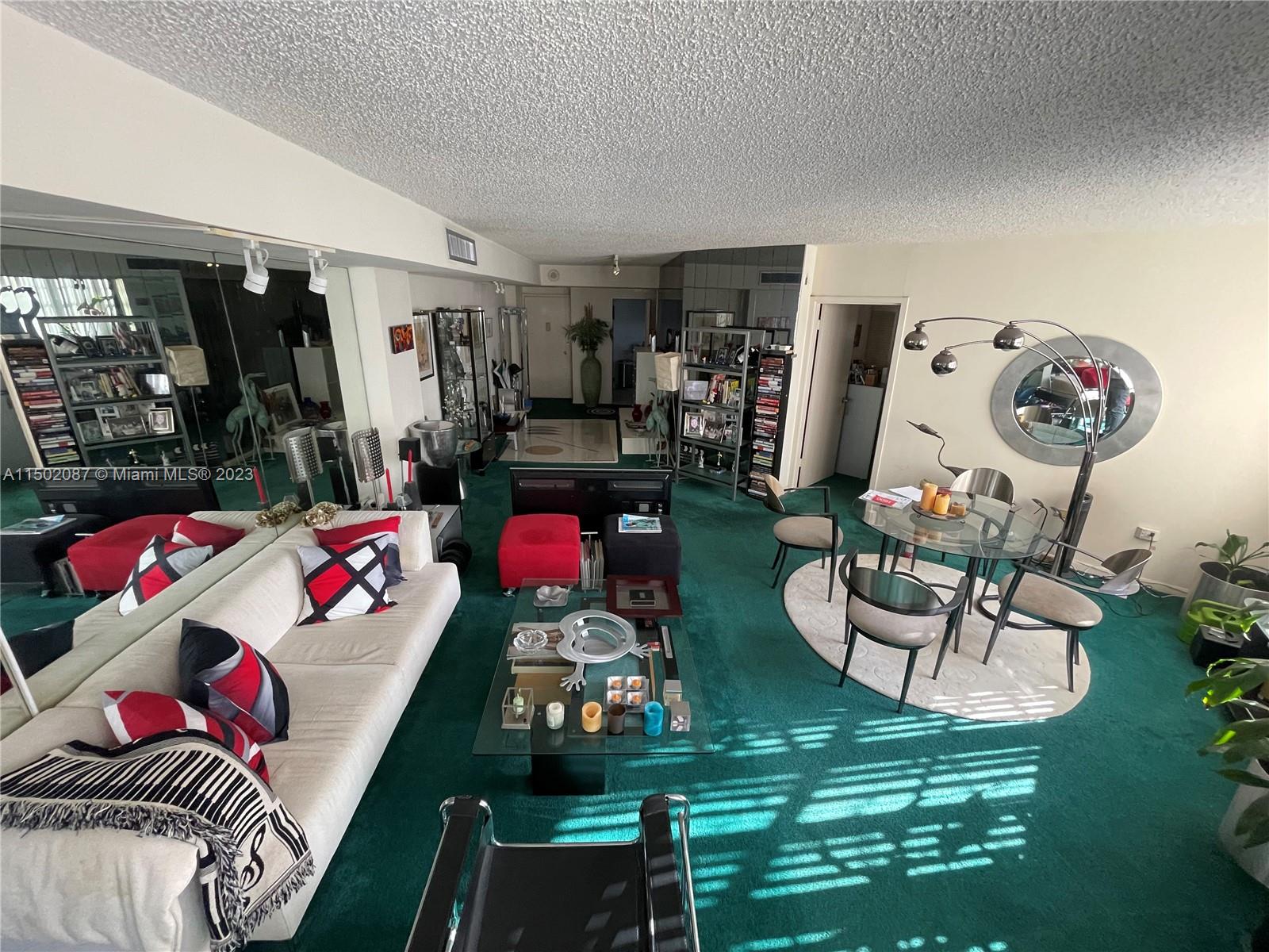 999 Brickell Bay Drive, Unit 1908 Miami, FL 33131 - Photo 40 of 57 a living room with furniture and a floor to ceiling window