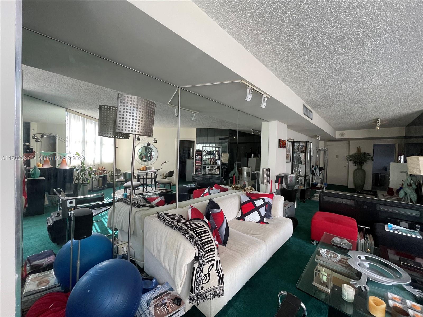 999 Brickell Bay Drive, Unit 1908 Miami, FL 33131 - Photo 41 of 57 a living room with furniture and a wooden floor