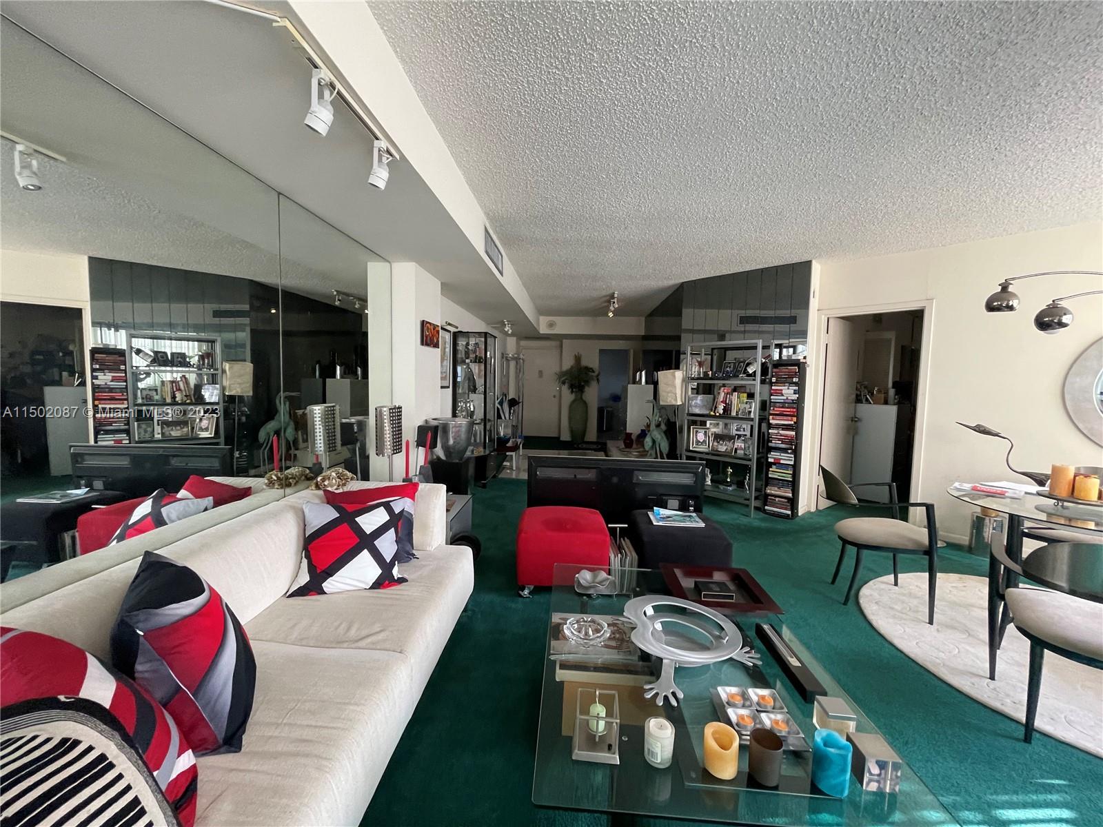 999 Brickell Bay Drive, Unit 1908 Miami, FL 33131 - Photo 42 of 57 a living room with lots of furniture and toys