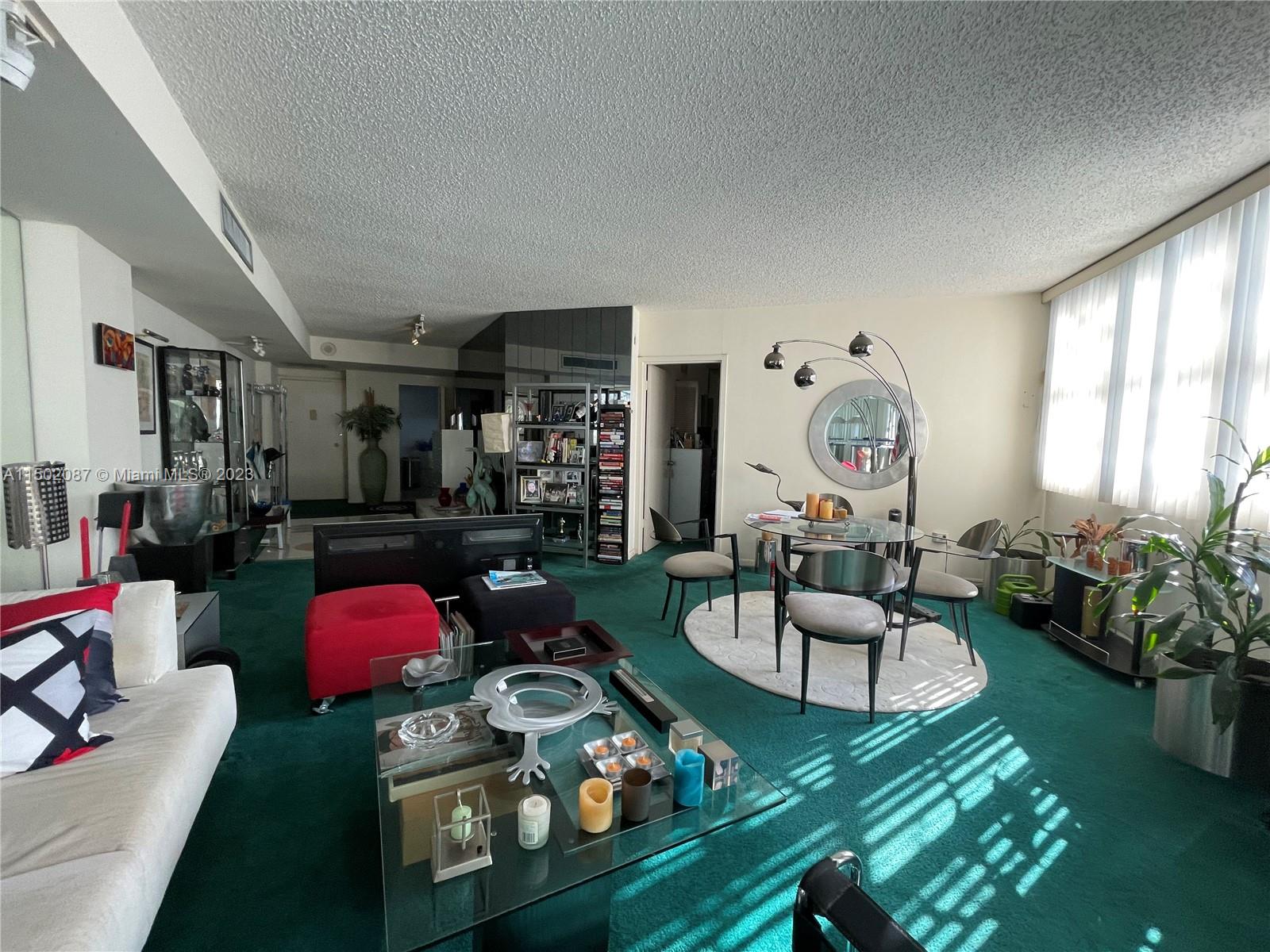 999 Brickell Bay Drive, Unit 1908 Miami, FL 33131 - Photo 43 of 57 a living room with furniture fireplace and a large window