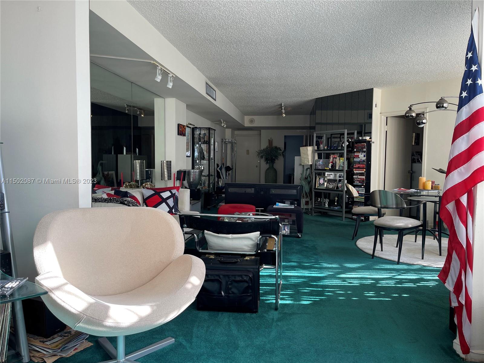 999 Brickell Bay Drive, Unit 1908 Miami, FL 33131 - Photo 47 of 57 a living room with furniture and a fireplace