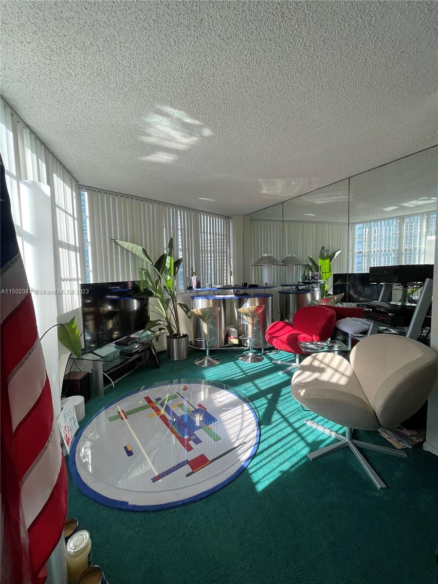 999 Brickell Bay Drive, Unit 1908 Miami, FL 33131 - Photo 56 of 57 a living room with furniture and a fireplace