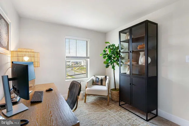 a bedroom with a bed and a potted plant
