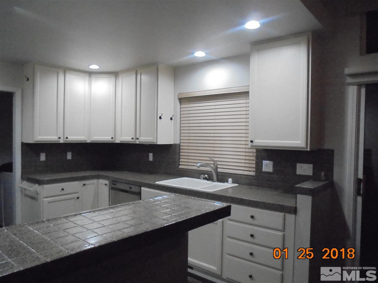 3635 Skyline Boulevard Reno, NV 89509 - Photo 13 of 37 a kitchen with granite countertop a sink and a stove