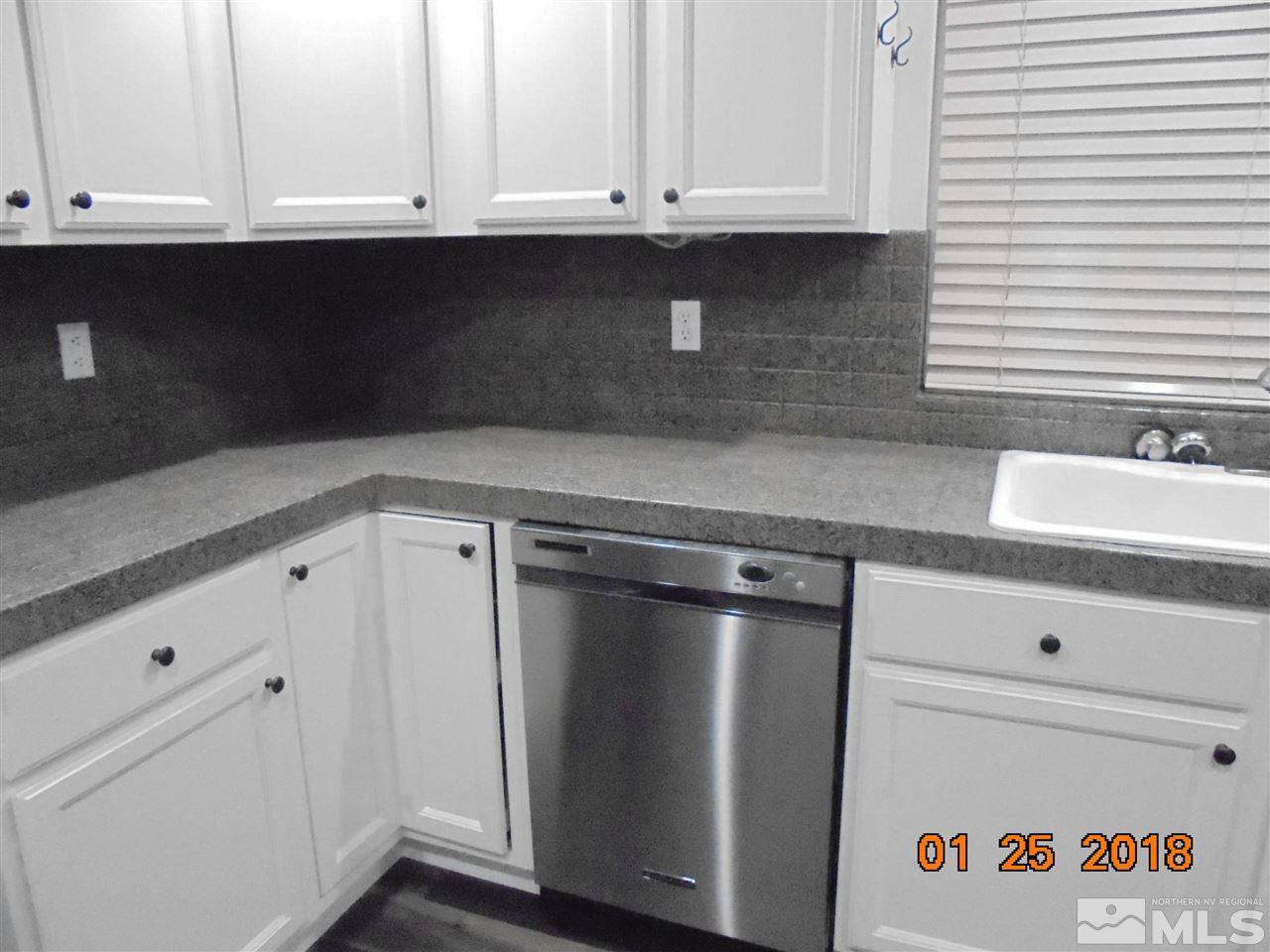 3635 Skyline Boulevard Reno, NV 89509 - Photo 16 of 37 a kitchen with granite countertop white cabinets and sink