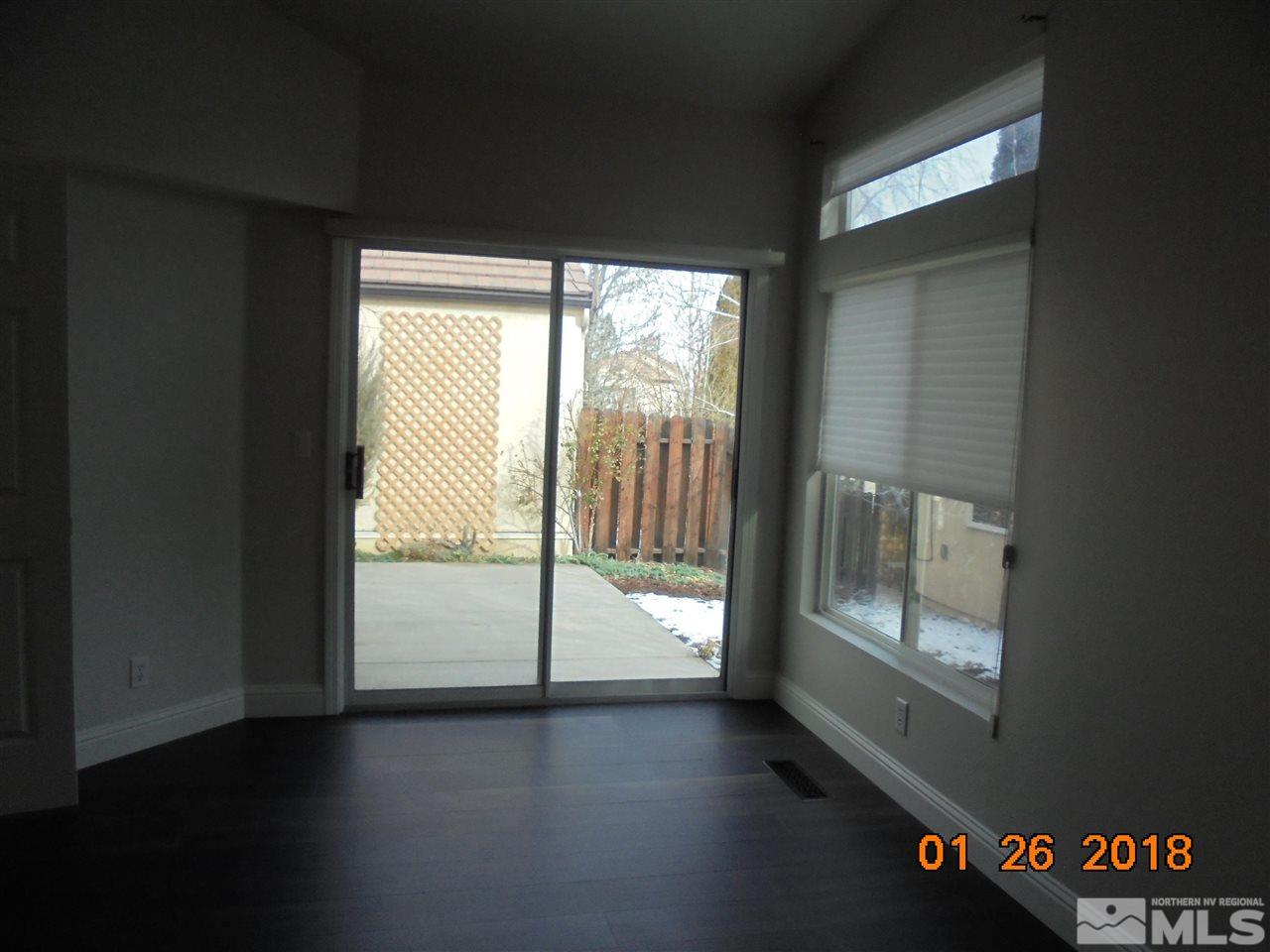 3635 Skyline Boulevard Reno, NV 89509 - Photo 20 of 37 an empty room with wooden floor and windows