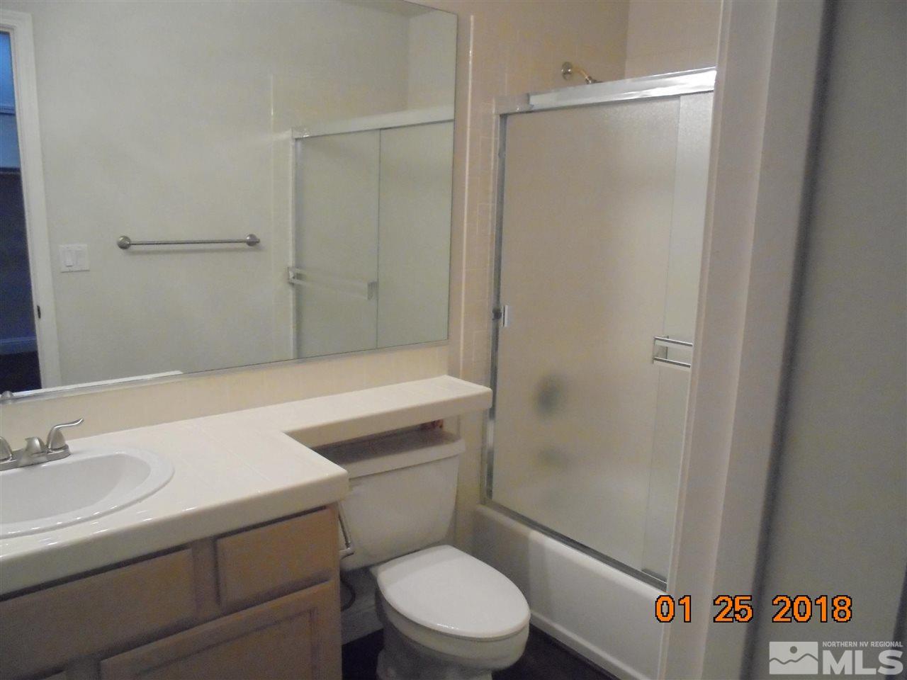 3635 Skyline Boulevard Reno, NV 89509 - Photo 2 of 37 a white toilet sitting next to a bathroom sink